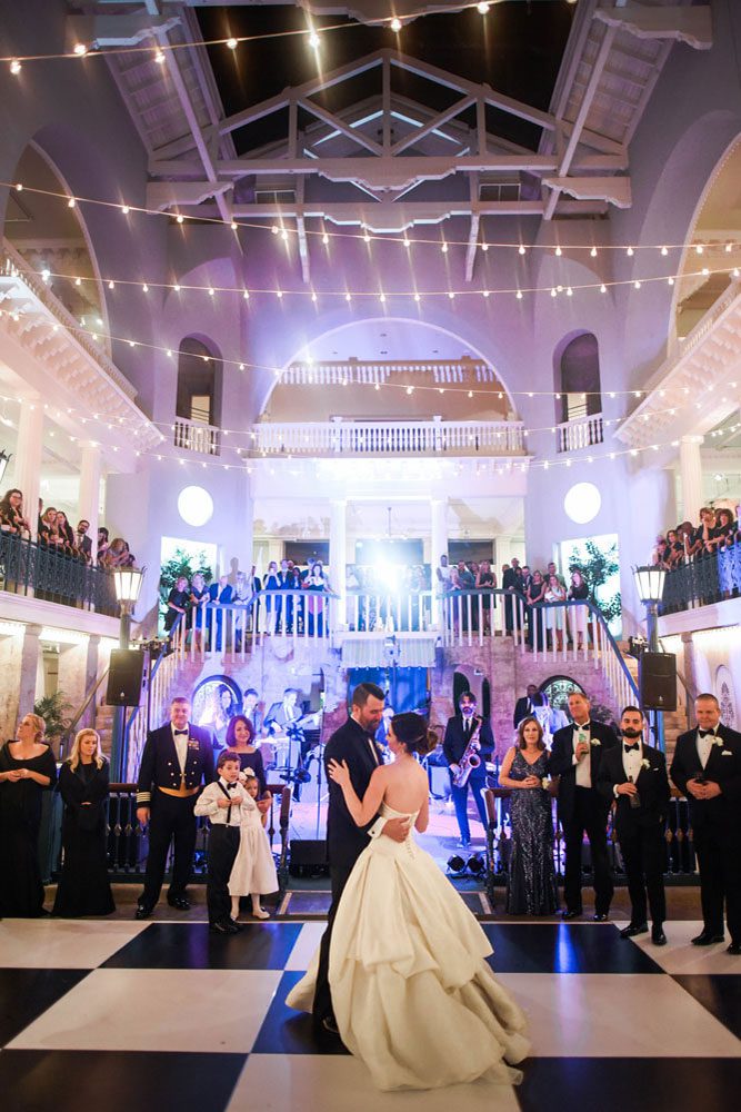 Bride and groom dance in the Historic Pool at the Lightner Museum