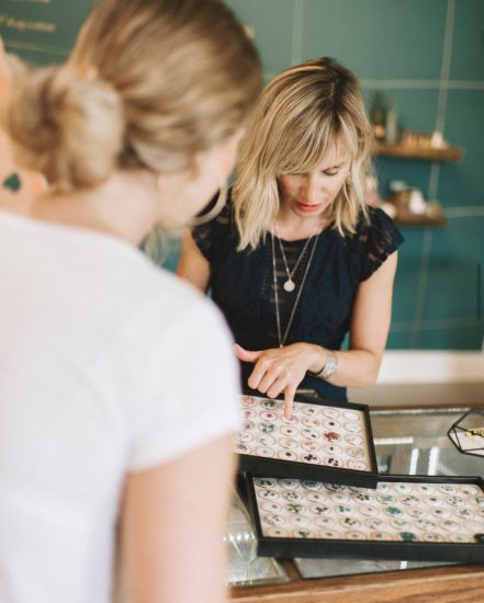 Laurel Baker, jewelry store owner, helps a customer find the perfect gemstone.