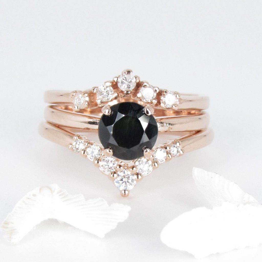 A stacked rose gold band with a black stone and diamonds make for a completely unique engagement ring.