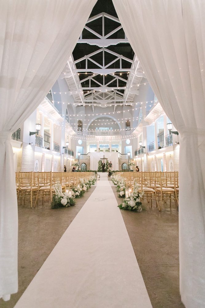 White wedding ceremony venue with gold chiavari chairs