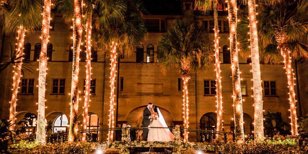 Photos in St. Augustine courtyard during holiday wedding at the Lightner Museum