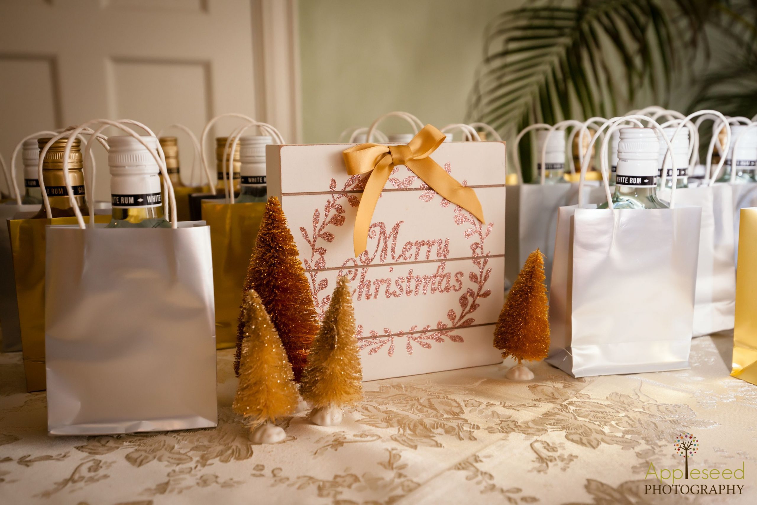 wedding favor bags set up with Merry Christmas sign