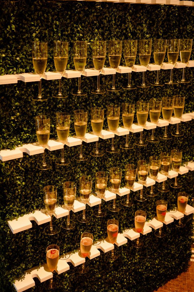 greenery wall to display glasses of champagne