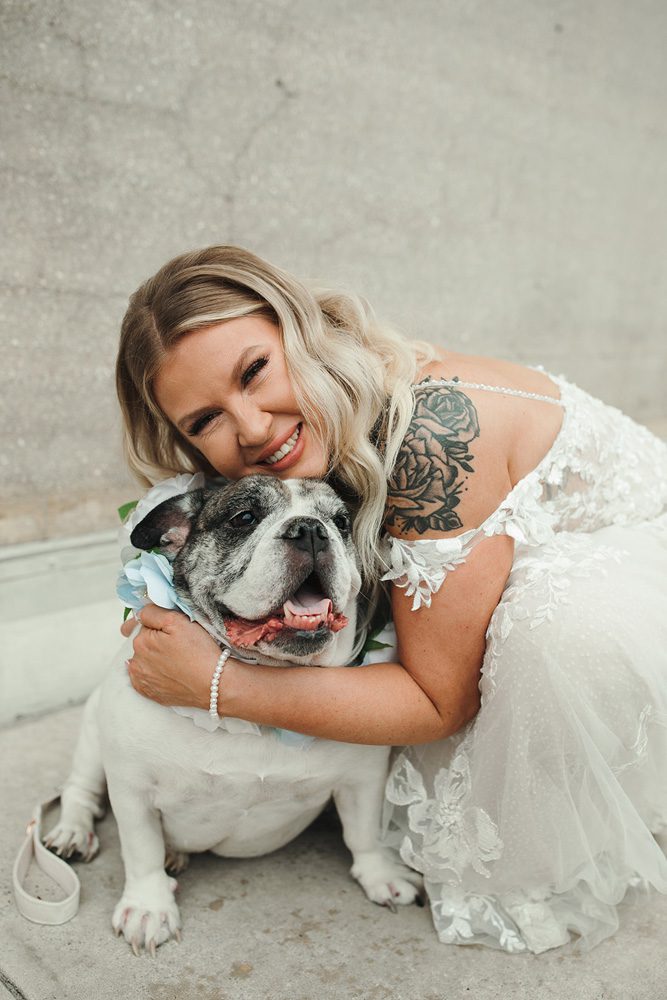 Bride hugging her dog
