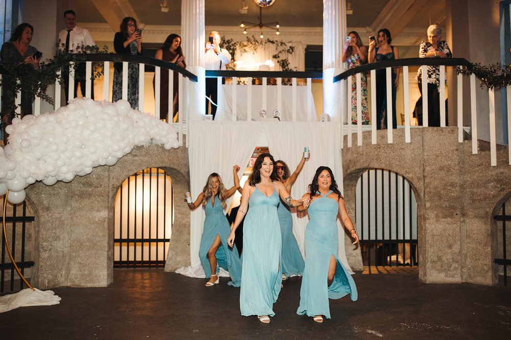 Bridesmaids make entrance to wedding reception