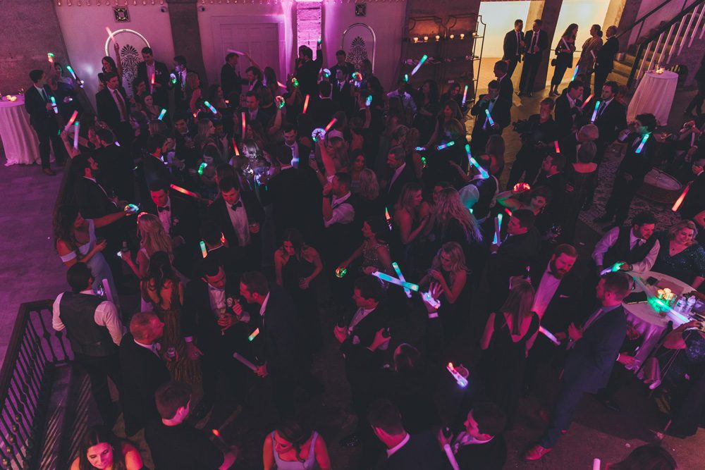 Guests dancing with neon props.
