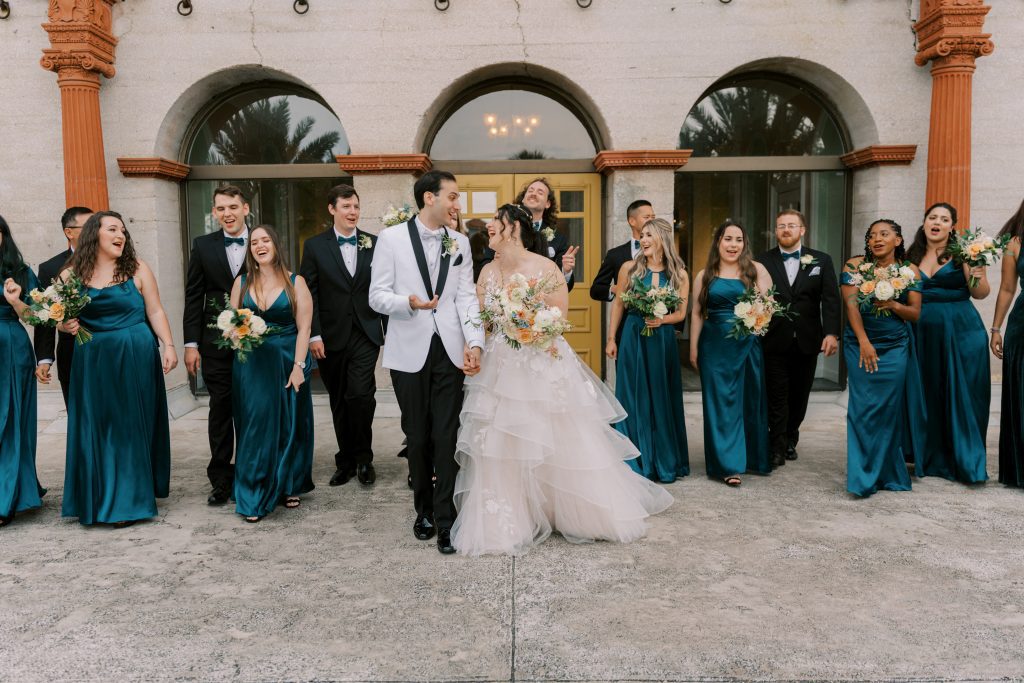 Cory and David with entire wedding party in front of the Lightner Museum