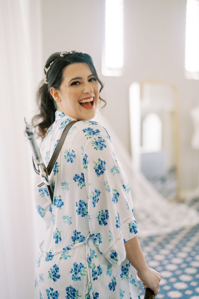 Bride Cory in floral robe with sword in harness over her shoulder