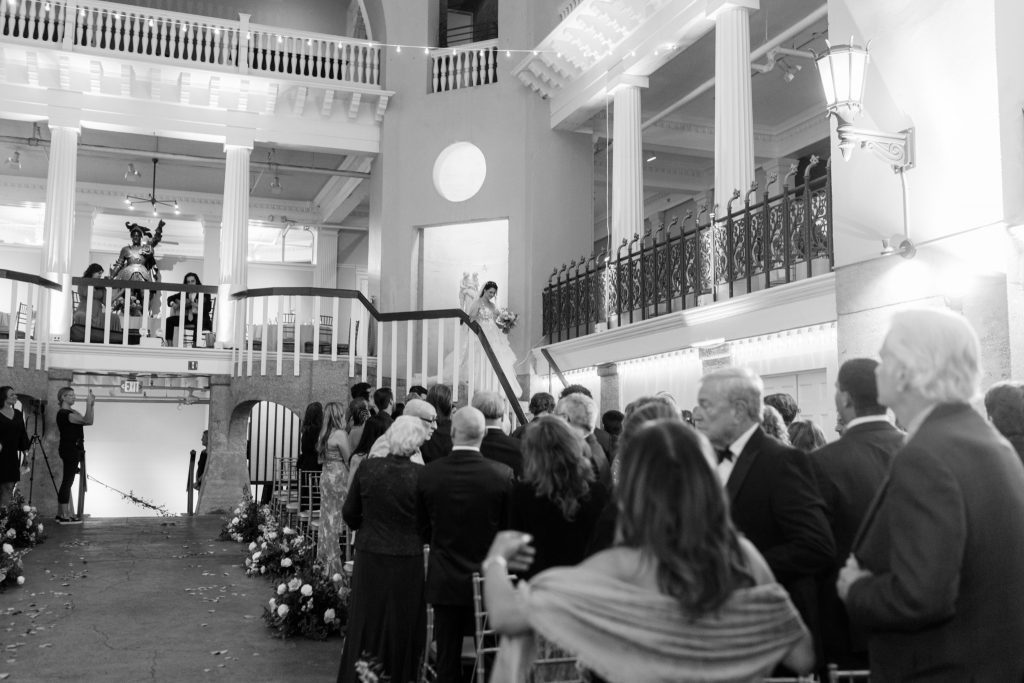 Bride Cory descending the staircase to walk down the aisle