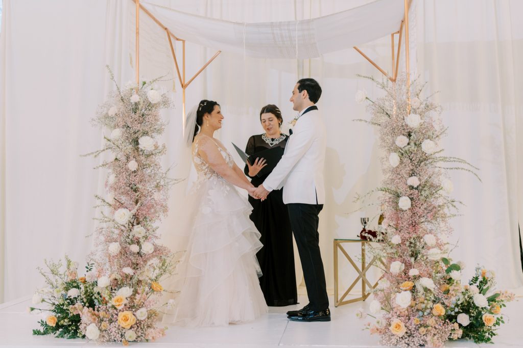 Cory and David underneath the chuppah at their wedding ceremony