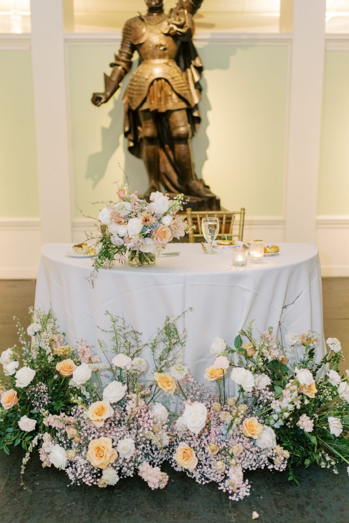 Sweetheart table in front of statue