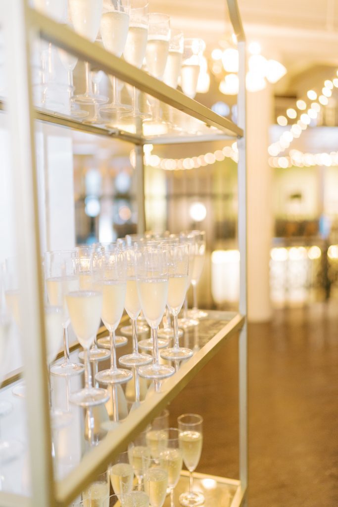 gold display shelving filled with champagne flutes