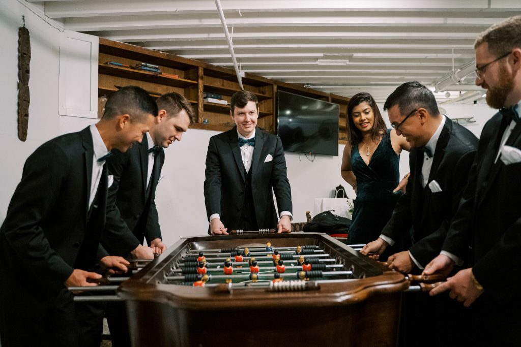 wedding party playing foosball in the Otto Lightner Lounge