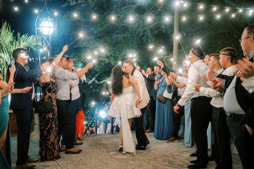 Bride and groom kissing before making their sparkler exit.