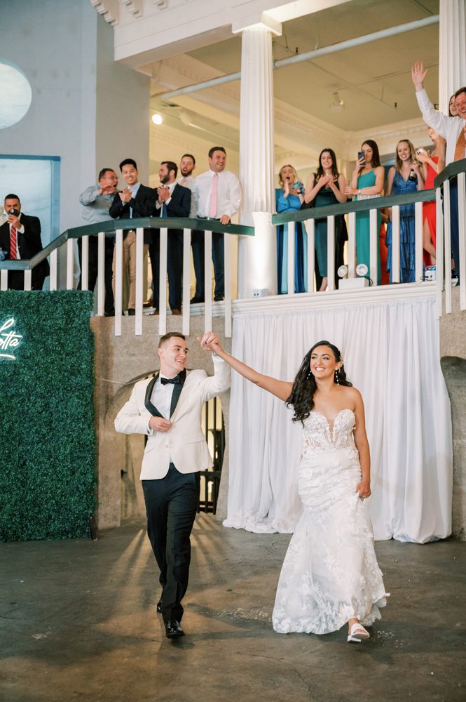 Bride and groom make their grand entrance to wedding reception