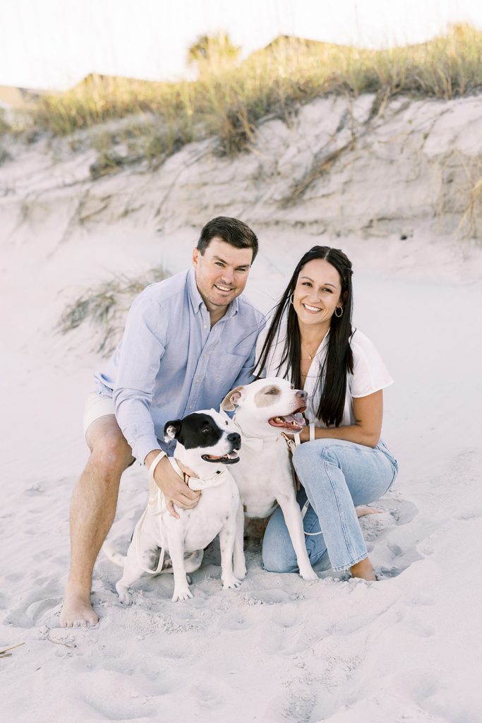 Engaged couple with their dogs at the beach
