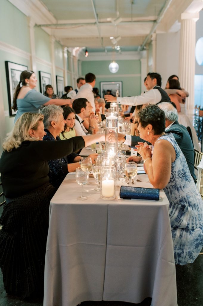 wedding guests at long rectangular table with cozy vibe