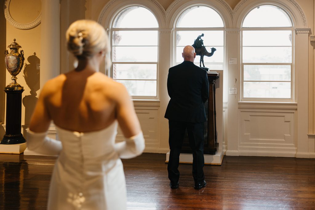 Bride Bri doing "first look" with her father before her wedding in the Lightner Museum