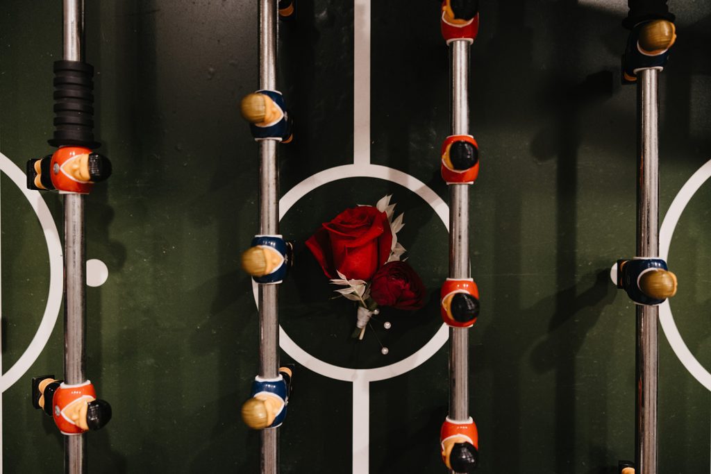 Rose boutonniere sitting in foosball table in the Otto Lightner Lounge