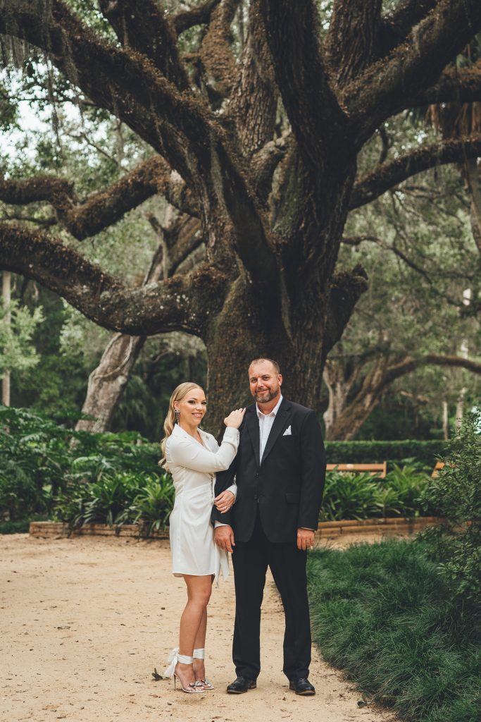 Engaged couple under old oak tree