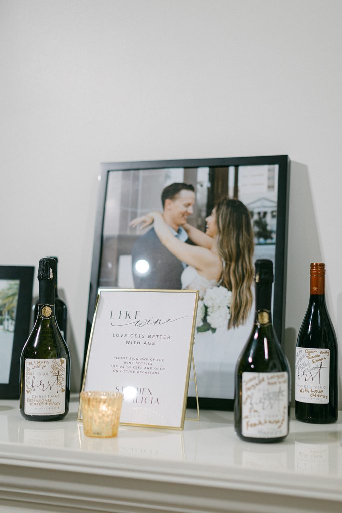 wine bottles with wedding guest signatures on the label