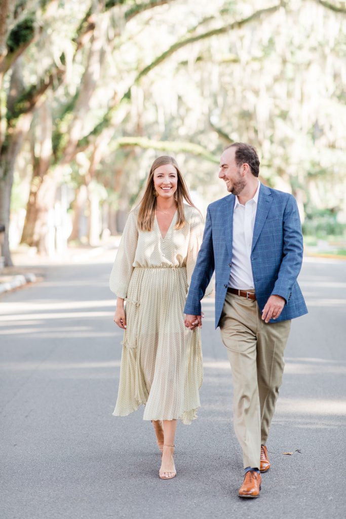 Engaged couple walking down the tree-lined Magnolia Avenue in St. Augustine