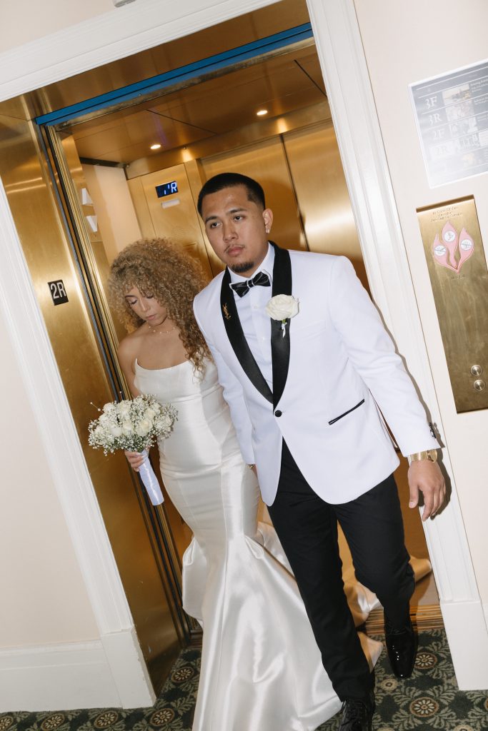 bride and groom exiting the elevator