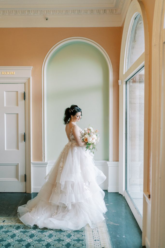 Bride standing near window