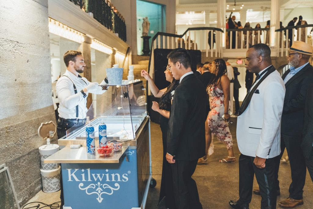 wedding guests lining up at Kilwins ice cream cart