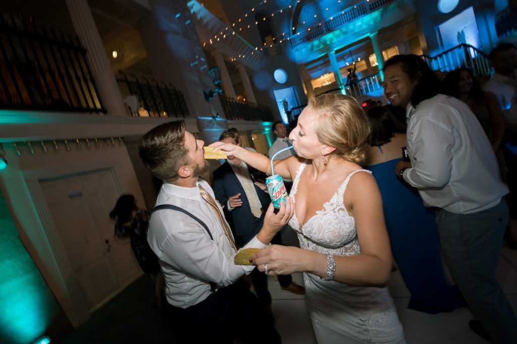 bride and groom feeding each other tacos and Mountain Dew